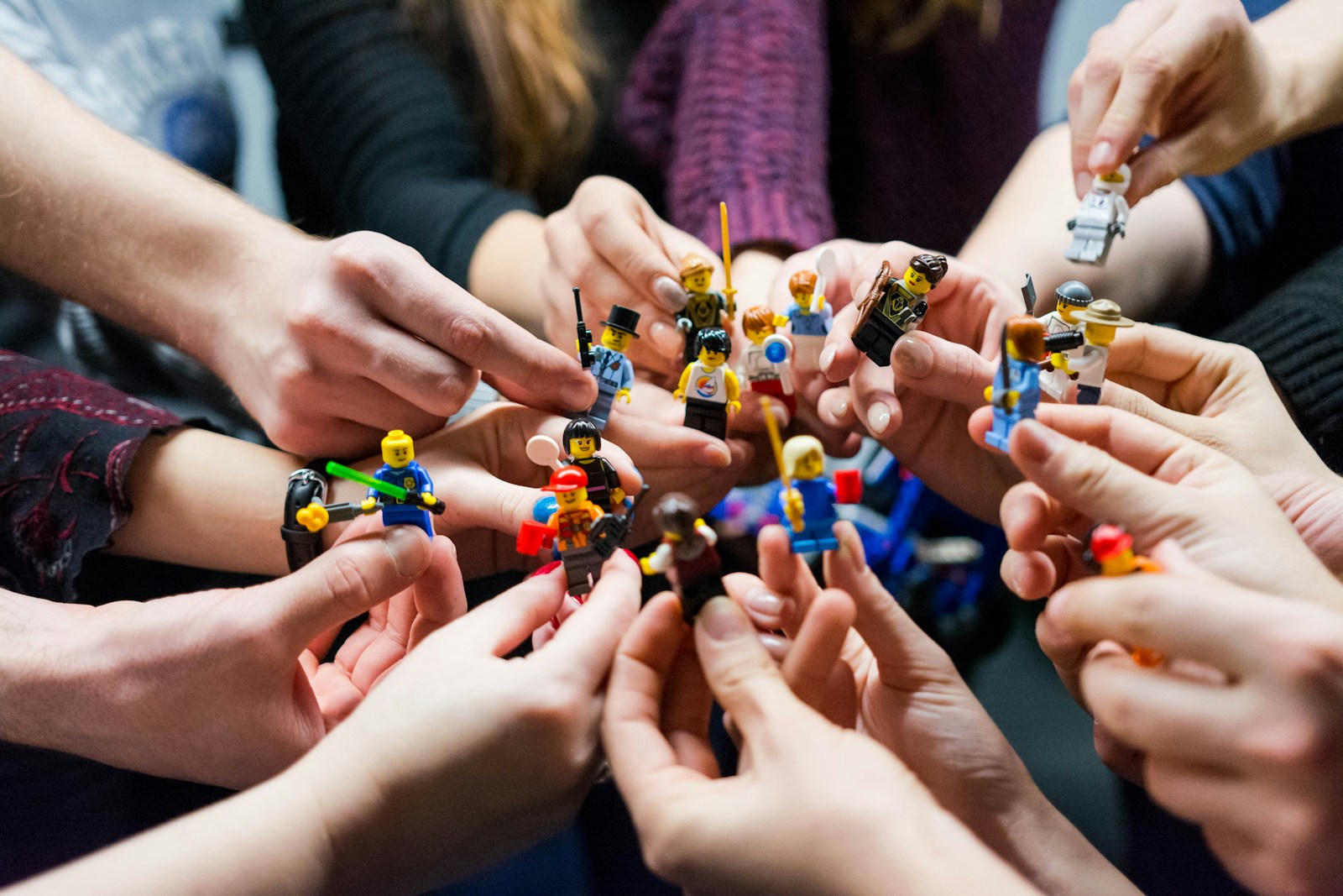 Photo by Vlad Hilitanu people holding miniature figures